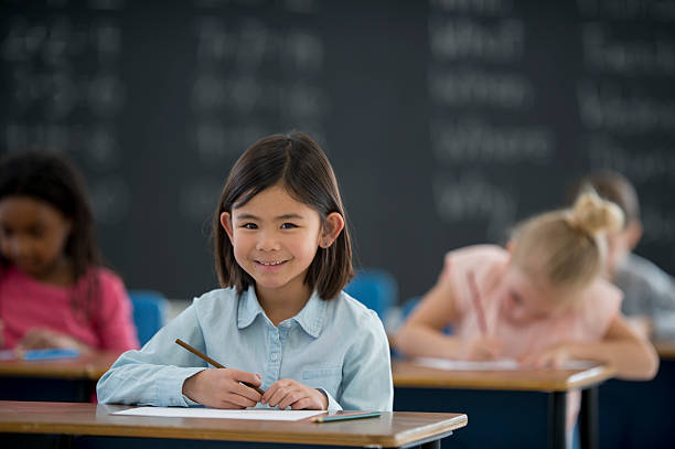 istock Schoolgirl Sitting at Her Desk 543329756