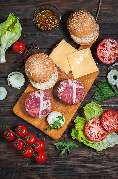 istock Ingredients for making homemade burger on wooden cutting board. 543332854