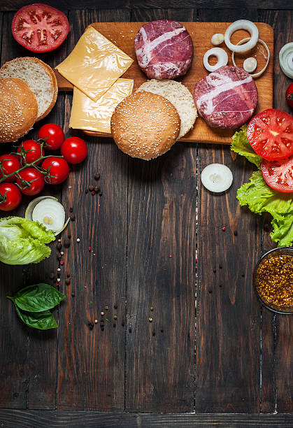 istock Ingredients for making homemade burger on wooden cutting board. 543332936
