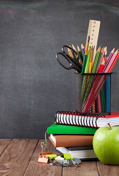 istock School and office supplies on classroom table 543336246