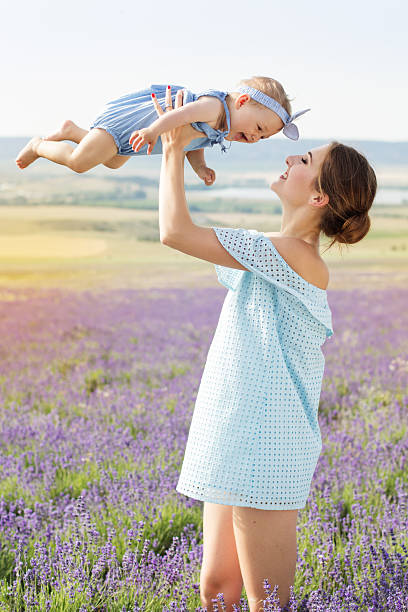 istock Mother and daughter having fun in lavender field 543336932