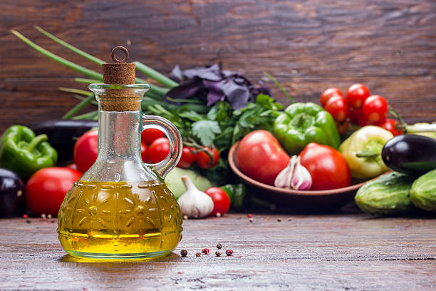 istock olive oil on vegetables background 543337136