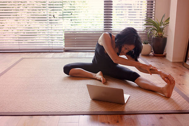 istock japanese female doing physical relaxation exercise with computer  kyoto japan 543338034