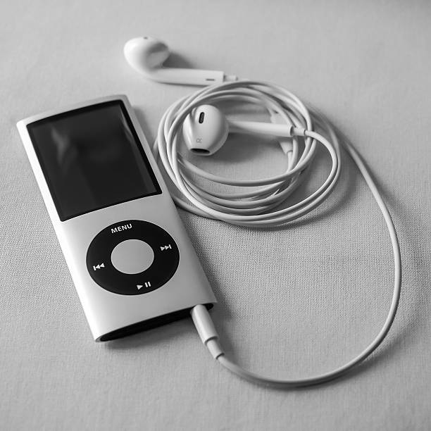 iPod Nano with Earpods in Black and White Berry, Australia - June 23, 2016: An Apple  iPod Nano 4th generation, with Apple Earpods attached, in black and white. ipod nano stock pictures, royalty-free photos & images