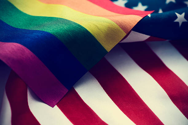 istock gay pride flag and American flag 543339152