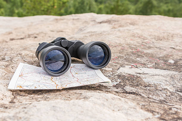 istock the binoculars on the old map orienteering Hiking direction 543339396