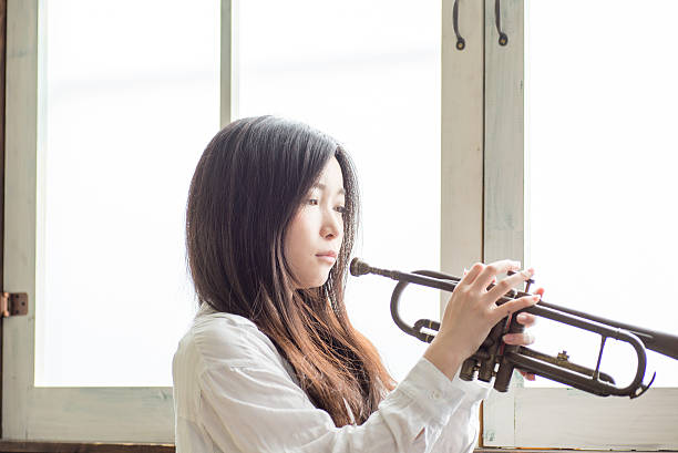 istock Beautiful Young Japanese Woman is practicing trumpet 543343858
