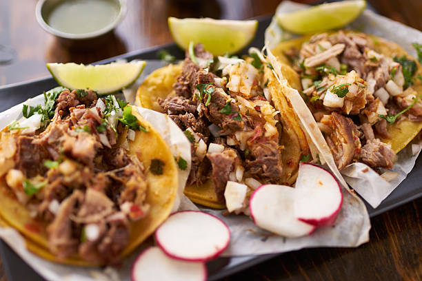 mexican street tacos with chicken, carnitas and barbacoa mexican street tacos with chicken, carnitas and barbacoa beef close up with radish slices tacos stock pictures, royalty-free photos & images