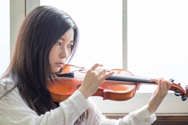 istock Beautiful Young Japanese Woman is practicing a violin 543344260