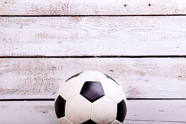 istock Soccer ball against wooden background. Studio shot. Copy space. 543344400