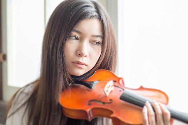 istock Beautiful Young Japanese Woman is practicing a violin 543344402
