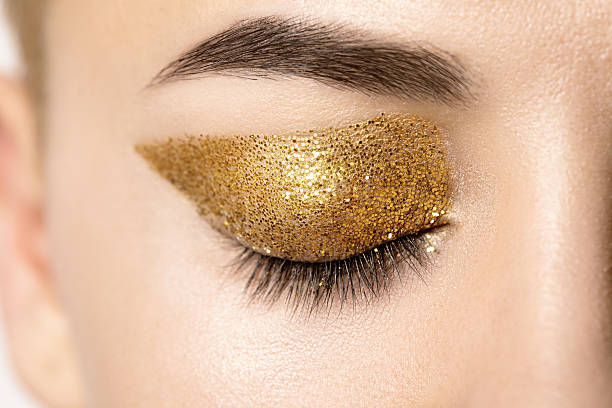 istock Macro female closed eye with gold glitter on the eyelid 543344420