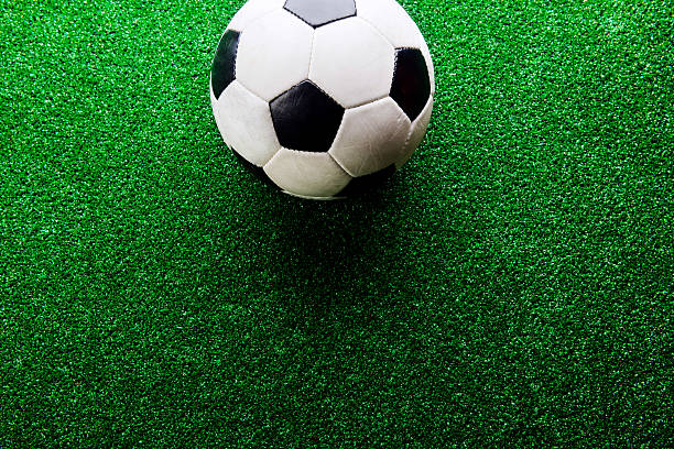 istock Soccer ball against artificial turf. Studio shot. Copy space. 543344920