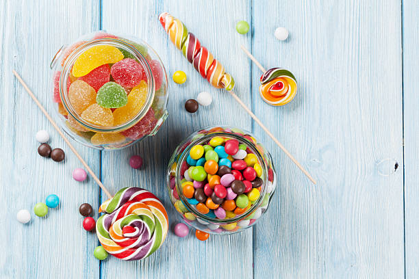 istock Colorful candies on wooden table 543345146