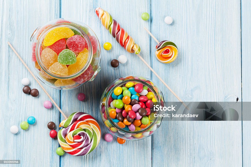 Colorful candies on wooden table Colorful candies on wooden table background. Top view Candy Stock Photo