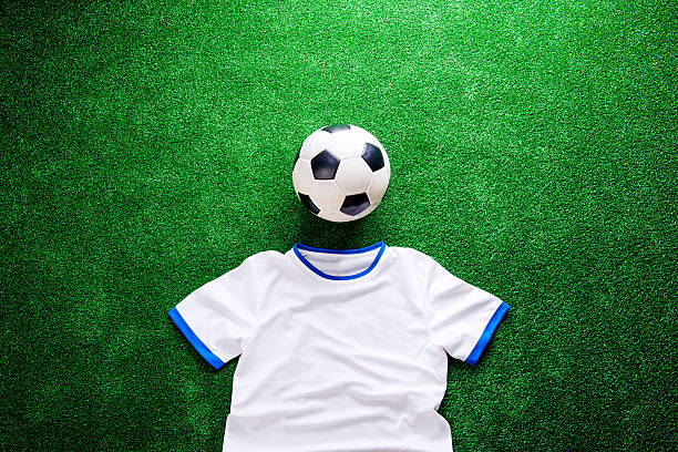 istock Soccer ball and white t-shirt against artificial turf 543345452