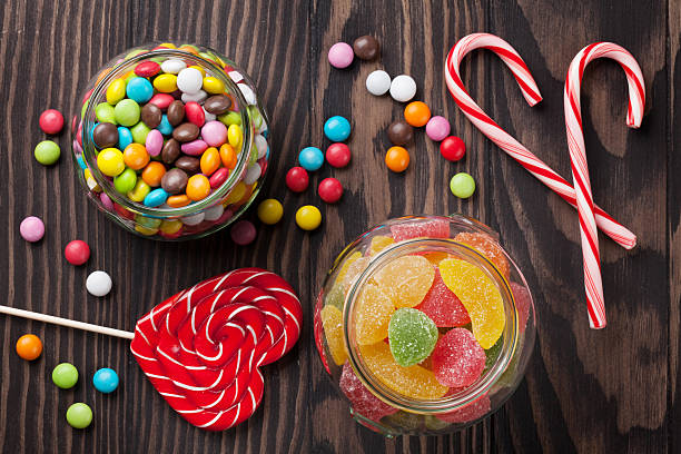 istock Colorful candies on wooden table 543345984