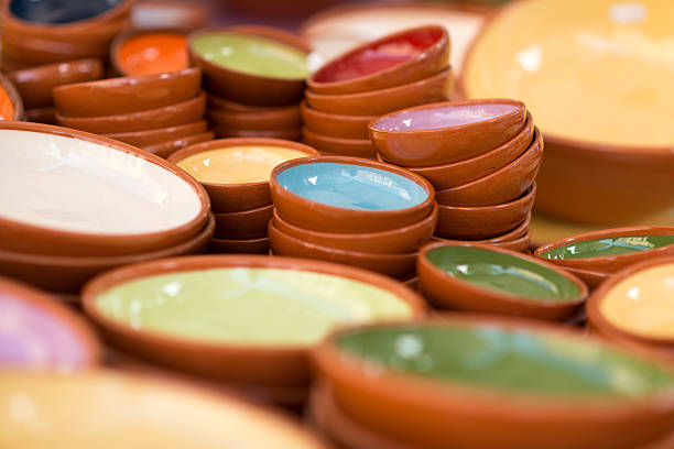 colorful pottery bowls on a market stall