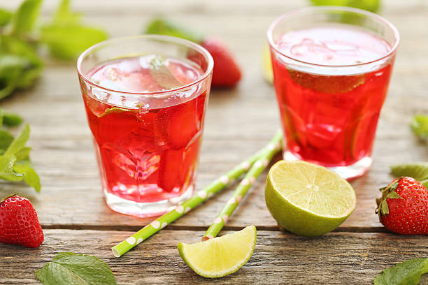istock Fresh strawberry drink in glass with lime on wooden table 543349086