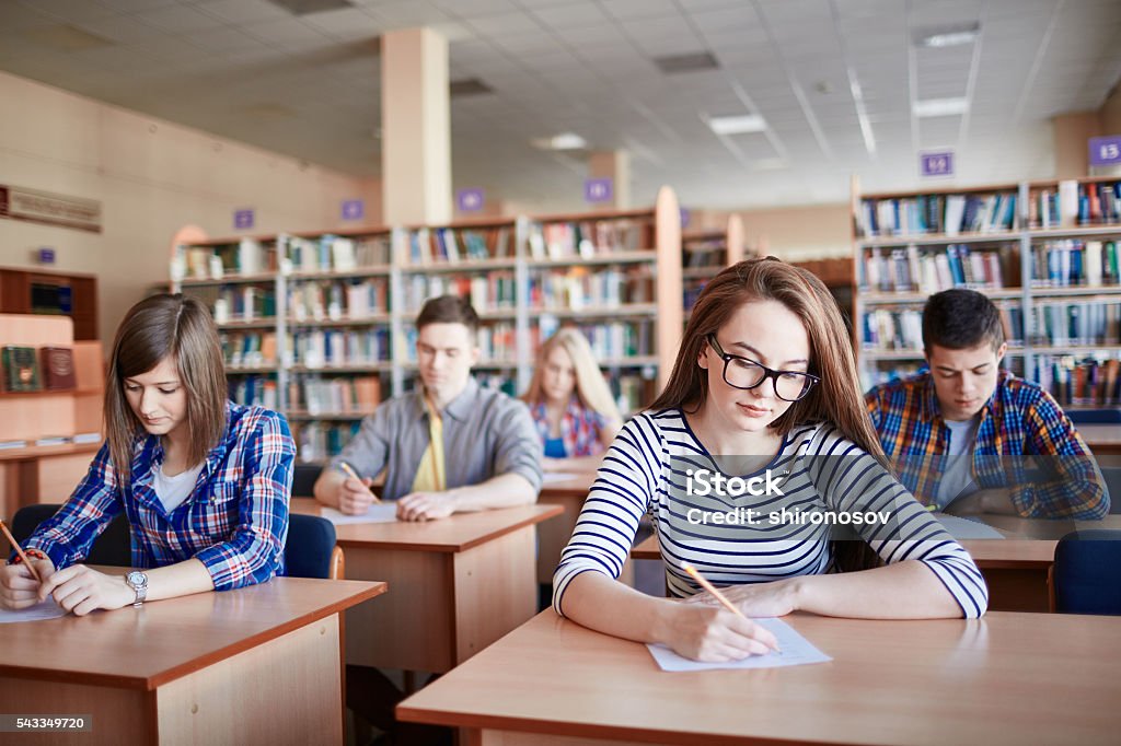 Final test Serious student writing test at college Educational Exam Stock Photo