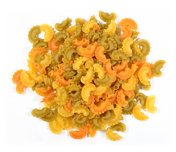 istock Heap of colored uncooked italian pasta on a white 543350280