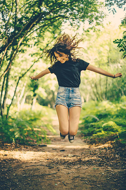 istock Girl jumping in the forest 543351000