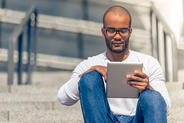 istock Afro American man with gadget 543351878
