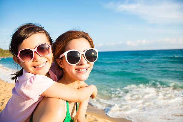 istock Mother and Daughter having fun on the beach 543354146