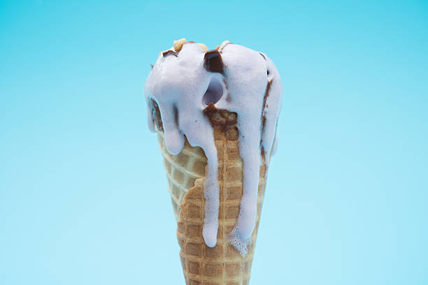 istock peanut flavor ice cream cone melting on a blue backgrond 543354582