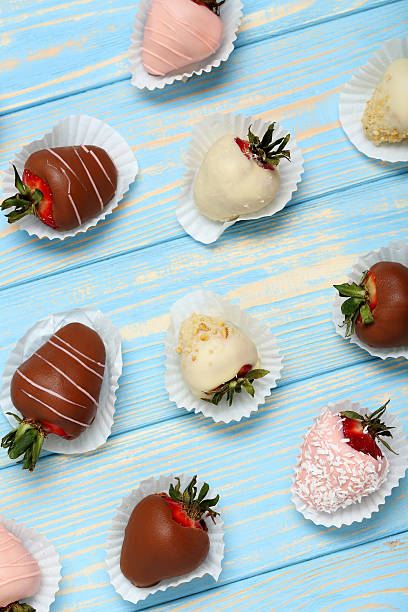 istock Strawberries covered in chocolate on a blue wooden table 543355306