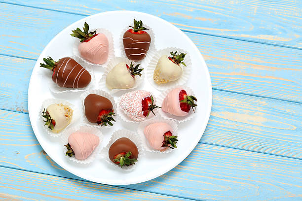 istock Strawberries covered in chocolate on a blue wooden table 543355384