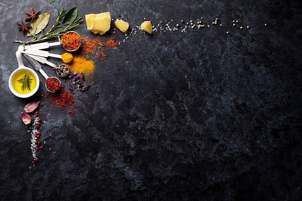 Herbs and spices over black stone Herbs and spices over black stone background. Top view with copy space pepper seasoning photos stock pictures, royalty-free photos & images