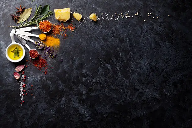 Photo of Herbs and spices over black stone