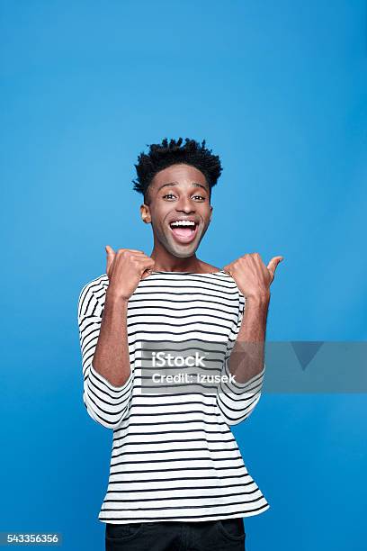 Excited Afro American Guy Stock Photo - Download Image Now - Happiness, Pointing, Adult