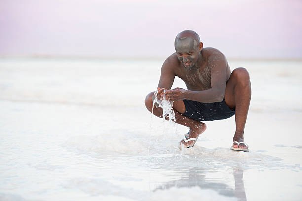 istock Man enjoying vacation on Dead Sea beach. 543357112