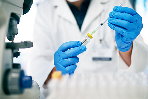 Cropped shot of a medical practitioner holding a syringe and a vial