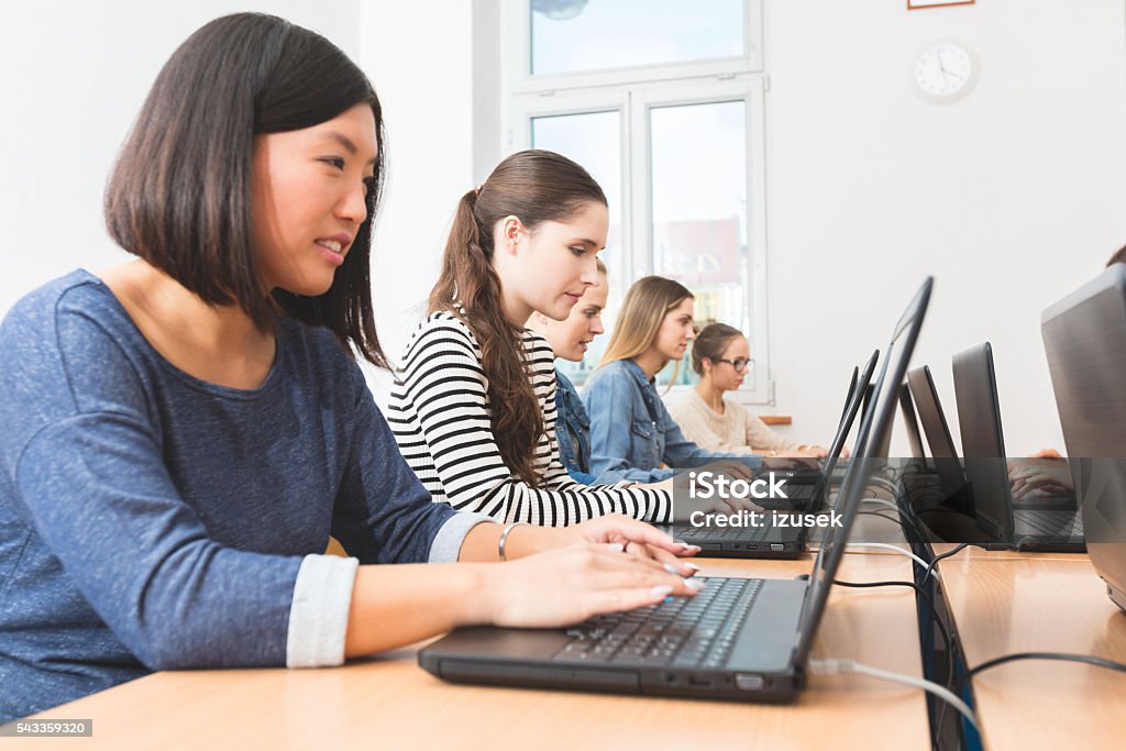 Female students learning computer programming Group of female students coding on laptops in a computer lab. Close up of asian young women typing on computer. Achievement Stock Photo