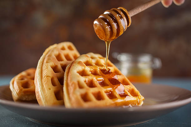 waffel mit honig - waffle syrup pouring breakfast stock-fotos und bilder