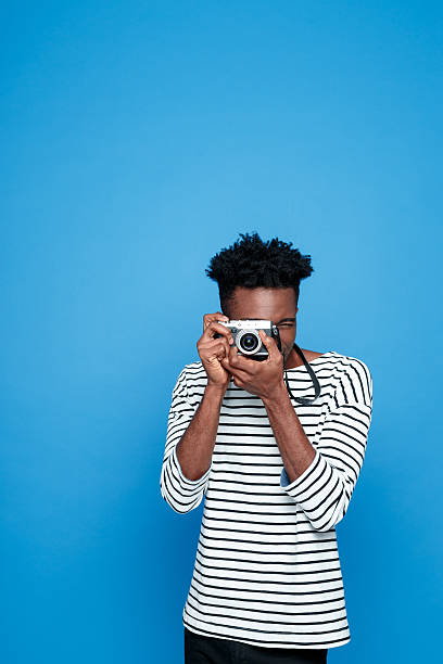 istock Afro american young man photographing 543361030