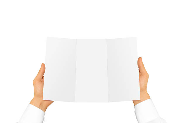 Hand in white shirt sleeve holding blank offset paper in