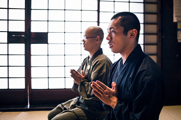 istock Young monks praying in Buddhist temple 543443952