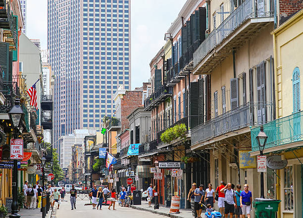 New Orleans, United States - May 14, 2015: View of Royal Street in French Quarter with its historic architecture, in the back modern highrises. Many people are strolling down the street.