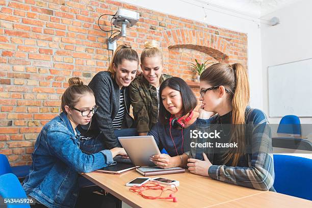 Group Of Friends Learning Together Working On Laptop Stock Photo - Download Image Now