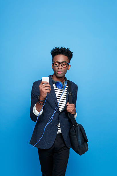 istock Fashionable afro american guy using a smart phone 543446138