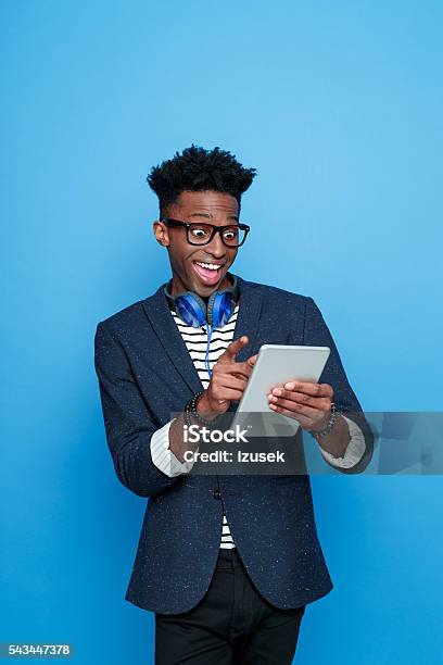 Happy Afro American Guy Using A Digital Tablet Stock Photo - Download Image Now - Digital Tablet, Human Face, Men