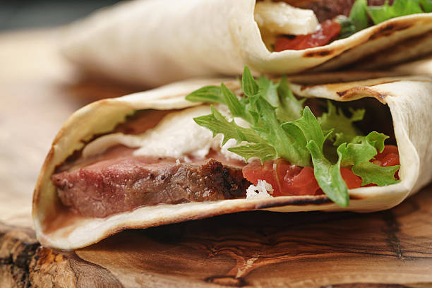istock fresh homemade burritos with beef on olive cutting board 543447808
