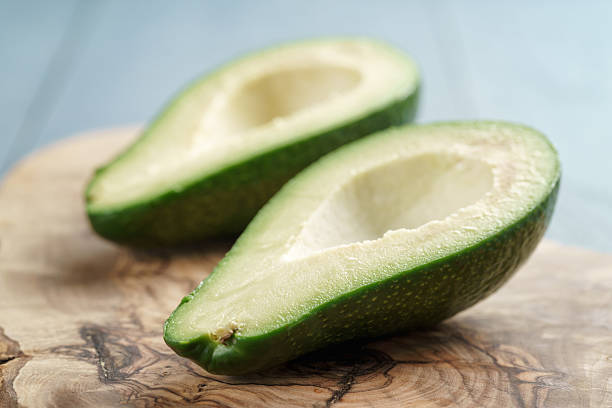 istock two halves of ripe avocado on cutting board over table 543448004