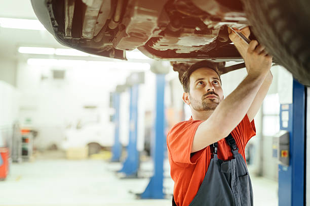 istock Car mechanic upkeeping car 543448944
