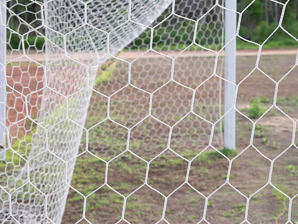 istock Soccer Goal Net with Green Grass Background 543451524