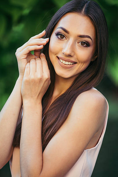 istock model beautiful girl standing in a park near tree 543453116